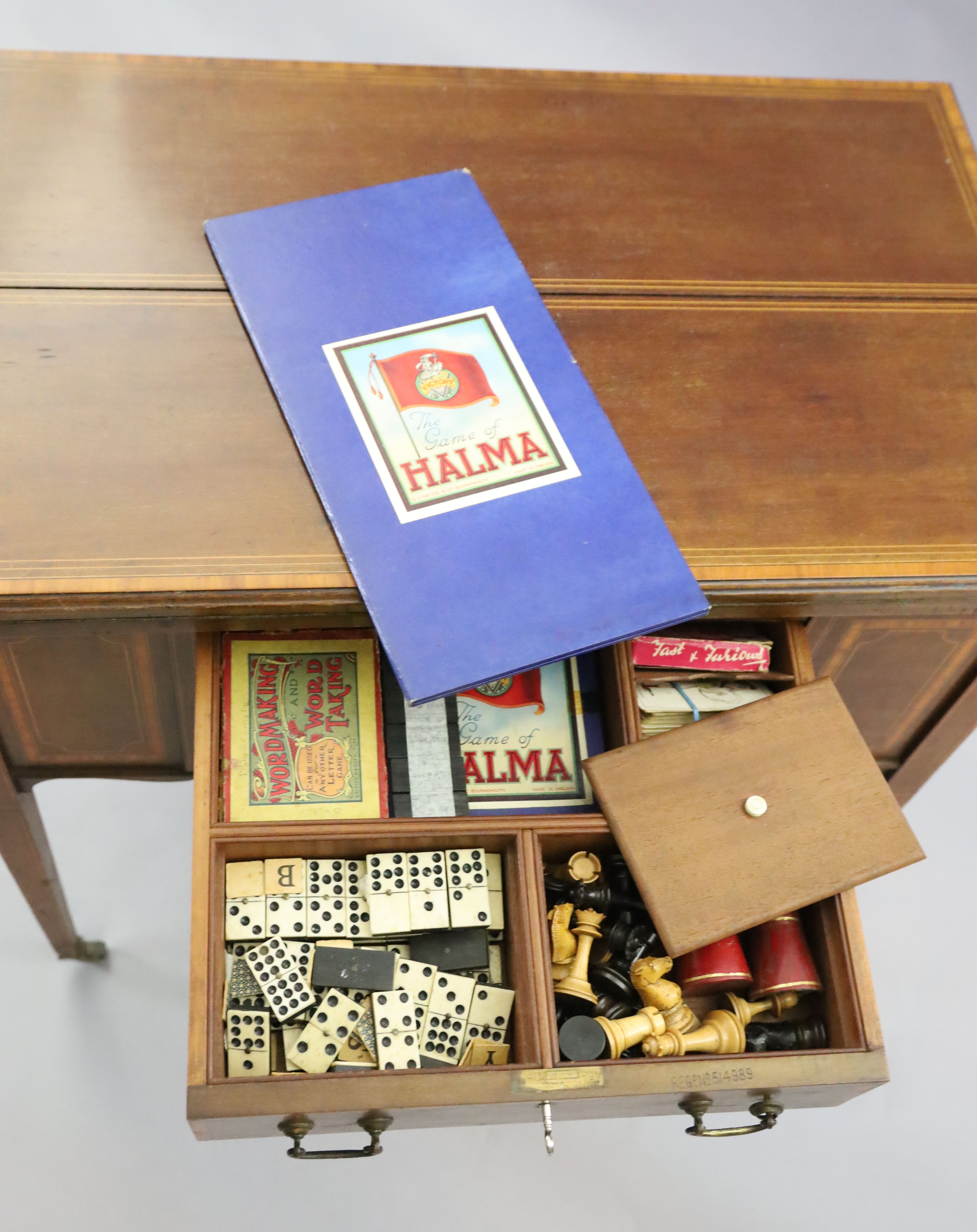 An Edwardian satinwood banded mahogany games/drinks table,